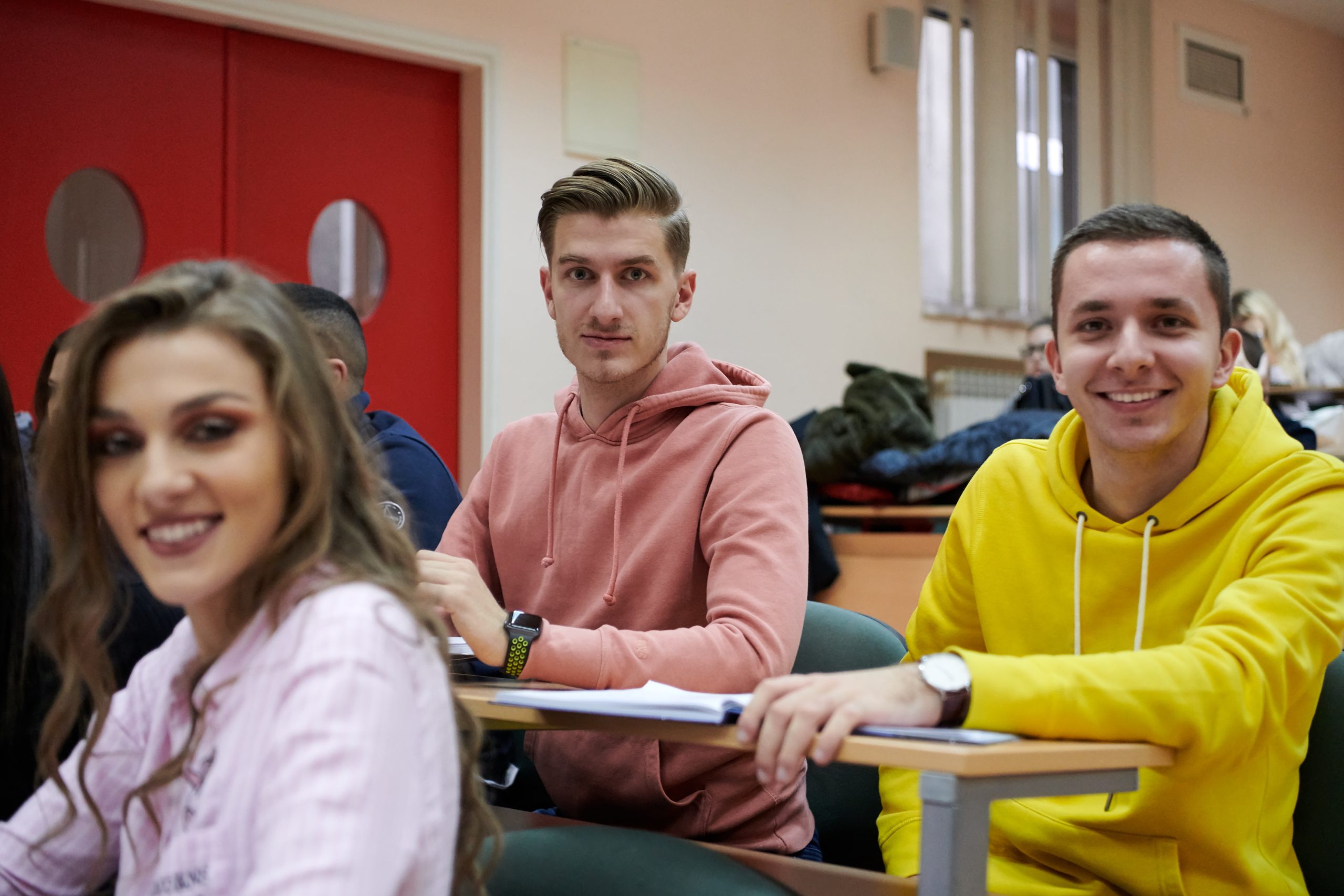 In the Classroom Multi Ethnic Students Listening to a Lecturer and Writing in Notebooks. Smart Young People Study at the College.